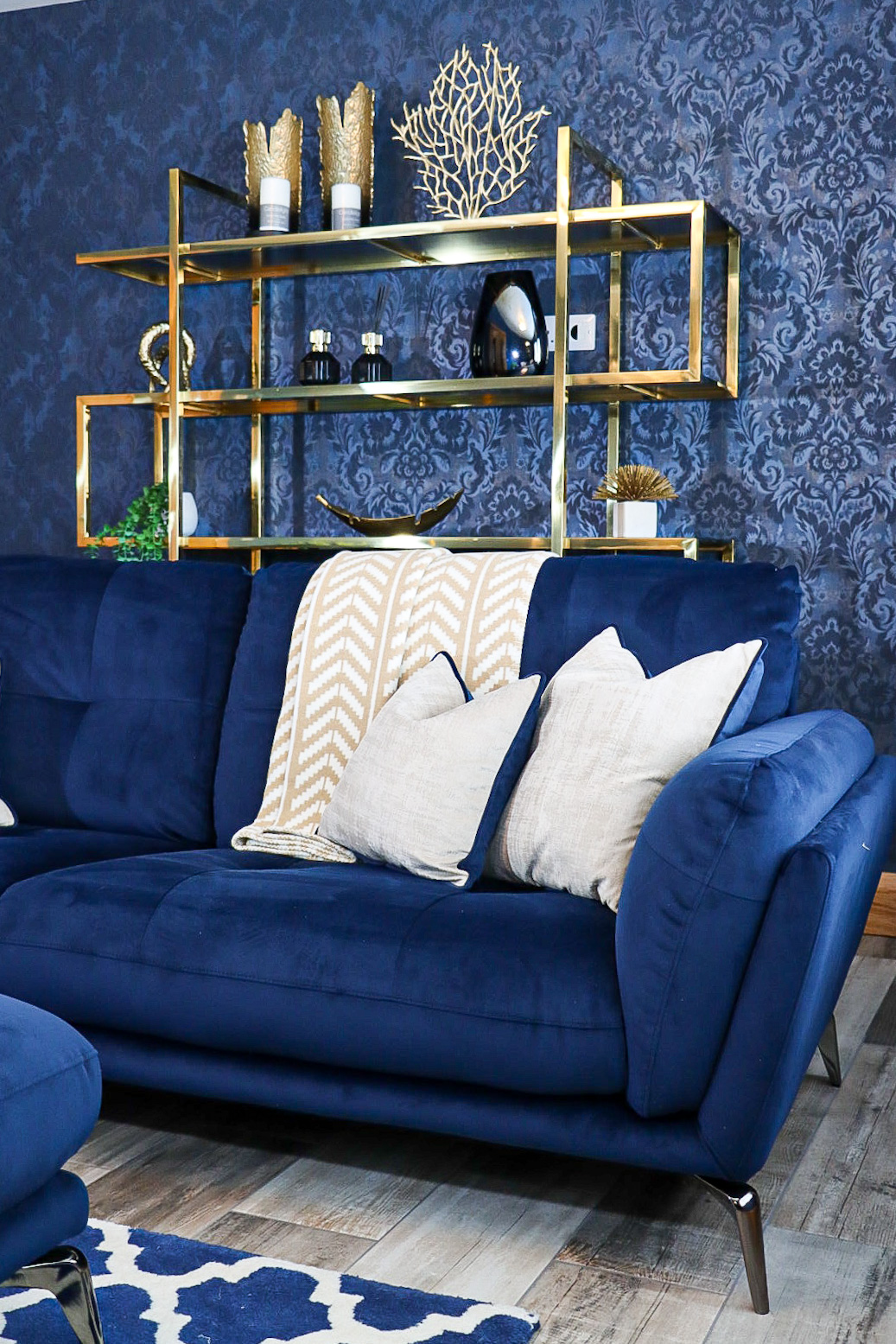 navy and gold modern livingroom with gold accessories, bespoke cushions and navy sofa