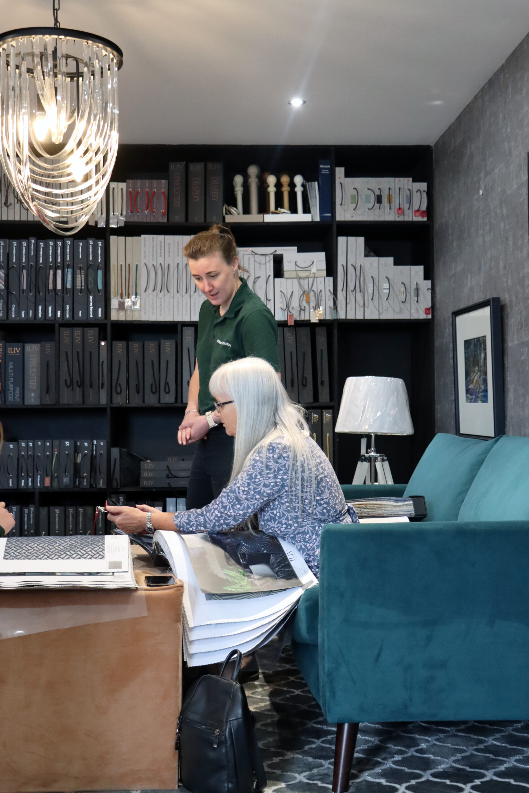 Interior Inspirations Shop with Sadie and a customer looking at Fabric Books